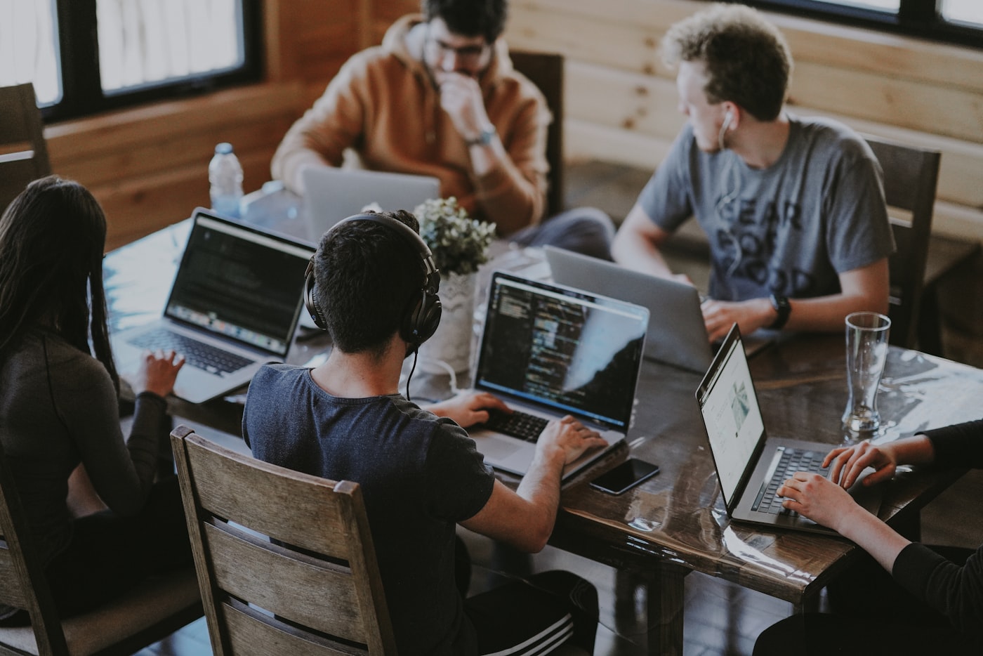 The 27 Tech Solutions team collaborating around a table in a bright office